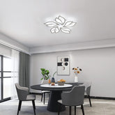 Modern dining room with a round table and chairs, decorative wall art, and ceiling light fixture.